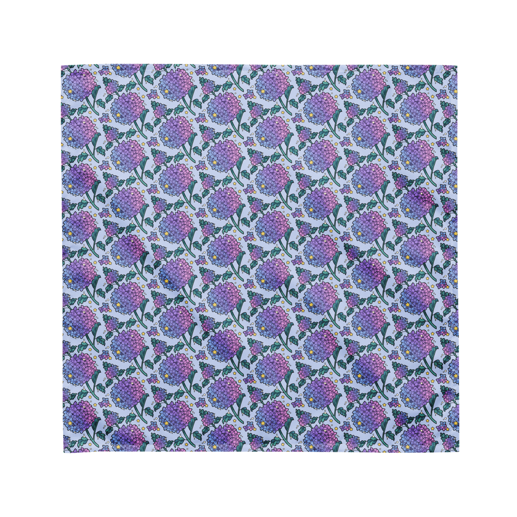 A blue bandana lying flat with a floral hydrangea pattern on it.