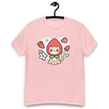 A cute pink shirt with a hand drawn illustration of a cat wearing a strawberry as a hat.