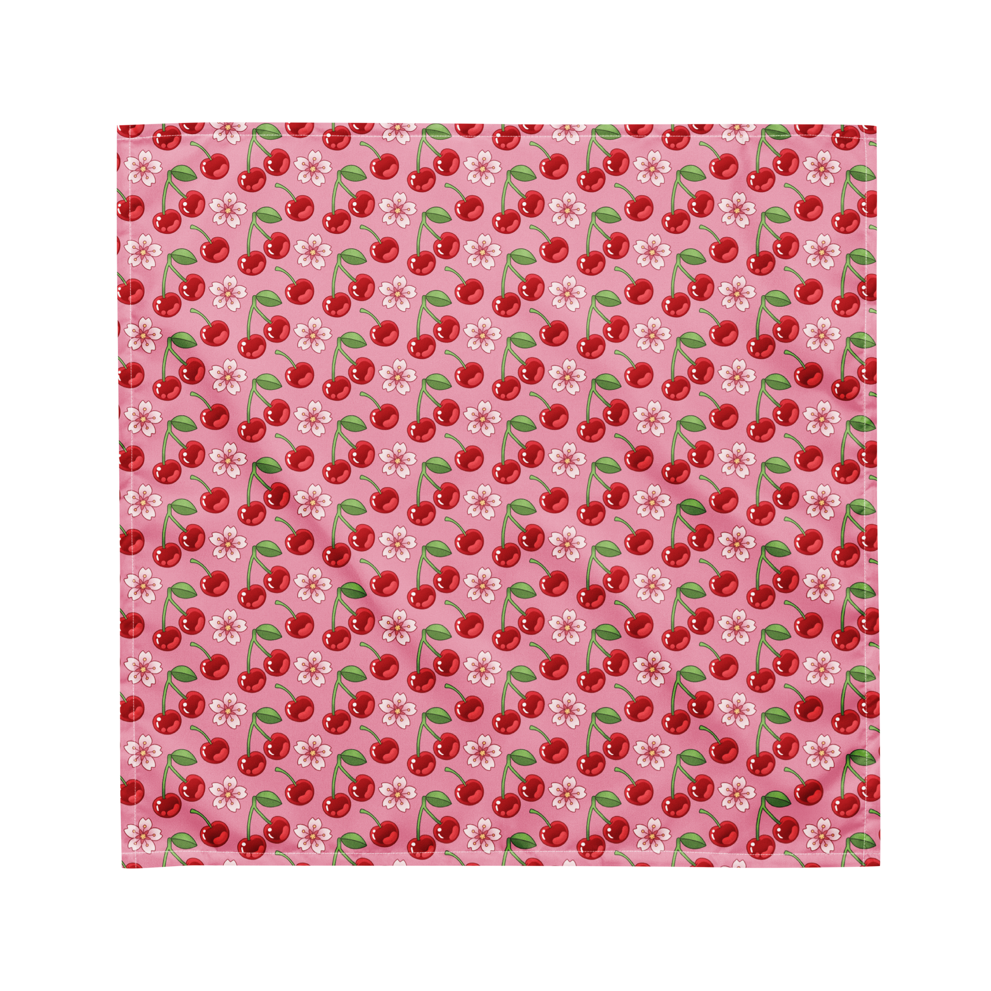 A cute pink bandana lying flat with a cherry and floral pattern on it. 