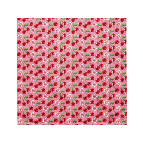 A cute pink bandana lying flat with a cherry and floral pattern on it. 